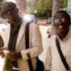 Cricket star Kyobe (right) with fan, Mugabi. PHOTO BY ISAAC SSEJJOMBWE