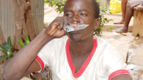 A man drinks alcohol in a sachet in Lira. FILE PHOTO