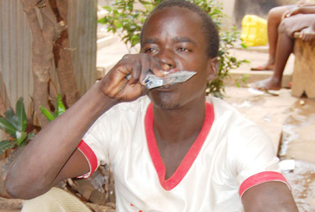 A man drinks alcohol in a sachet in Lira. FILE PHOTO