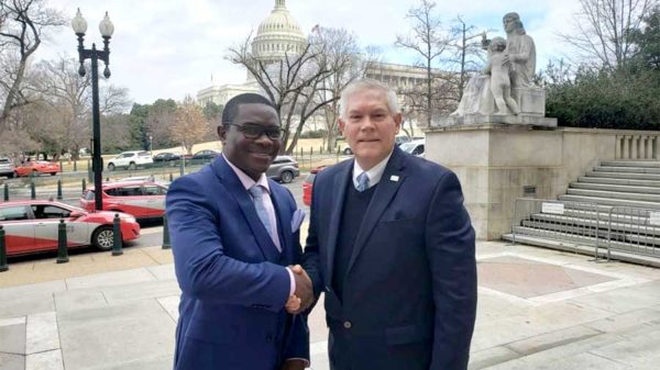 Men of importantance . Mr Pemba (L)shakes hands with Peter Anderson, an American politician from Texas who served in the US House of Representatives for 11 terms,soon after the important meeting at Washington DC senate